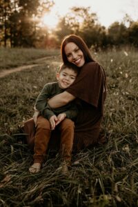 A mother and son in the sunset posing for photos.