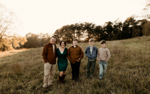 Family having fun during family photos in the sunset before having dinner in Marietta at my favorite places to eat.