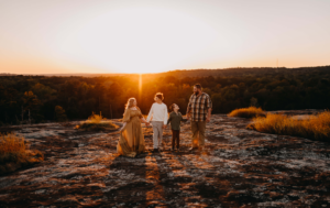 Family walking in the sunset for family photos.